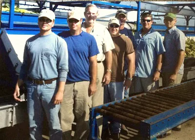 Members of the Hundley Farms team beside the packing belt